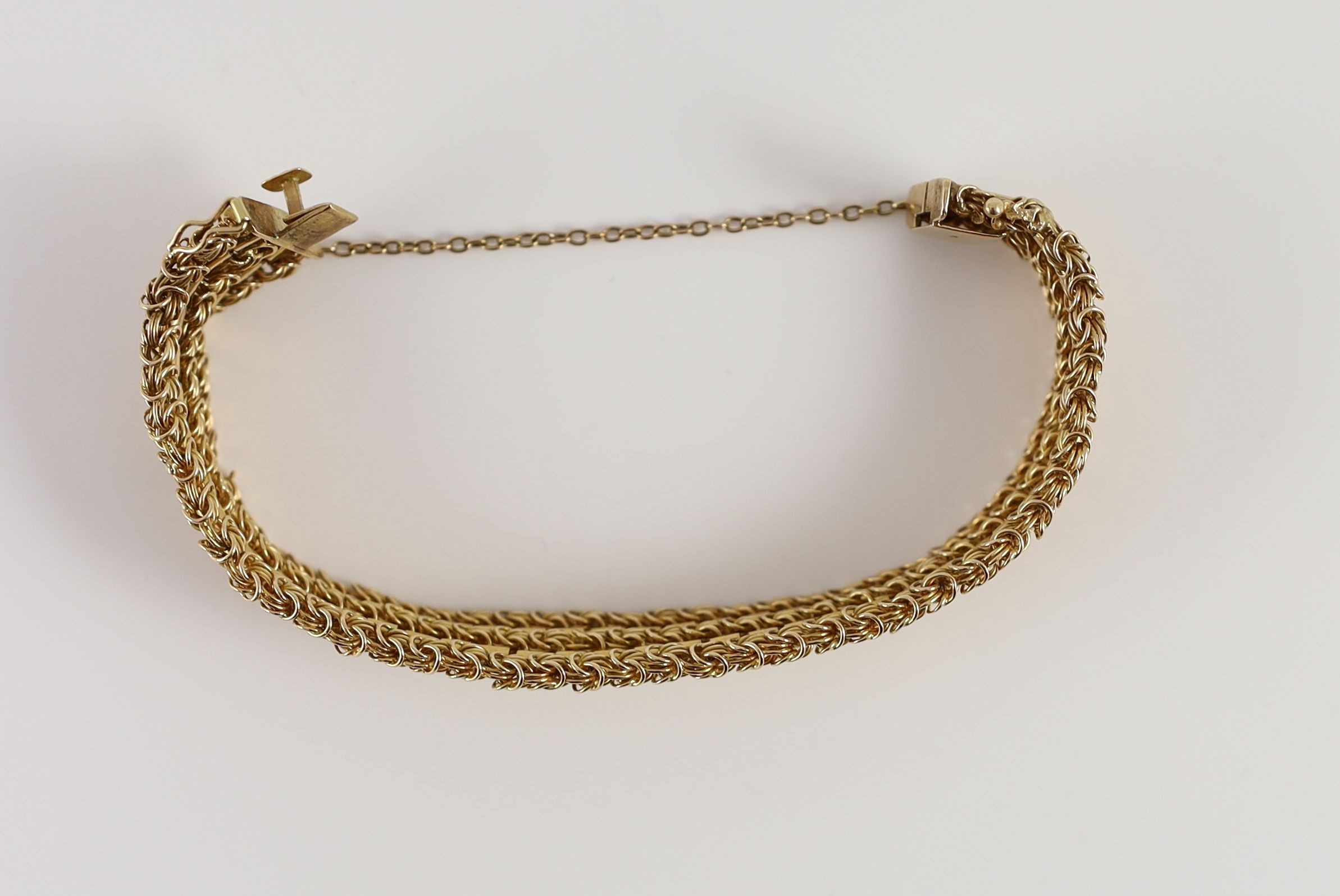 A 20th century 18k gold interwoven three row bracelet